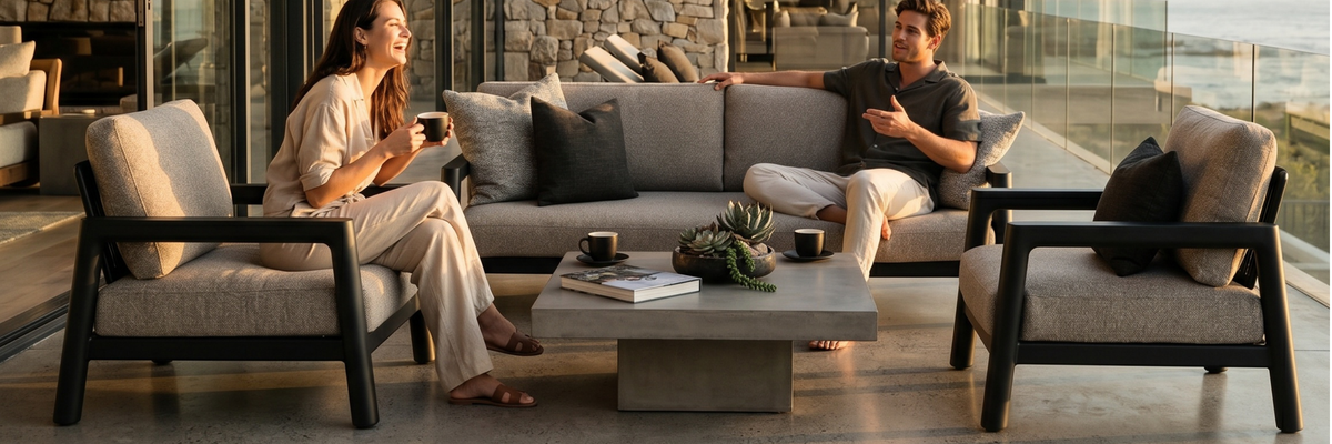 Friends dining around a modern outdoor patio set with table and chairs.