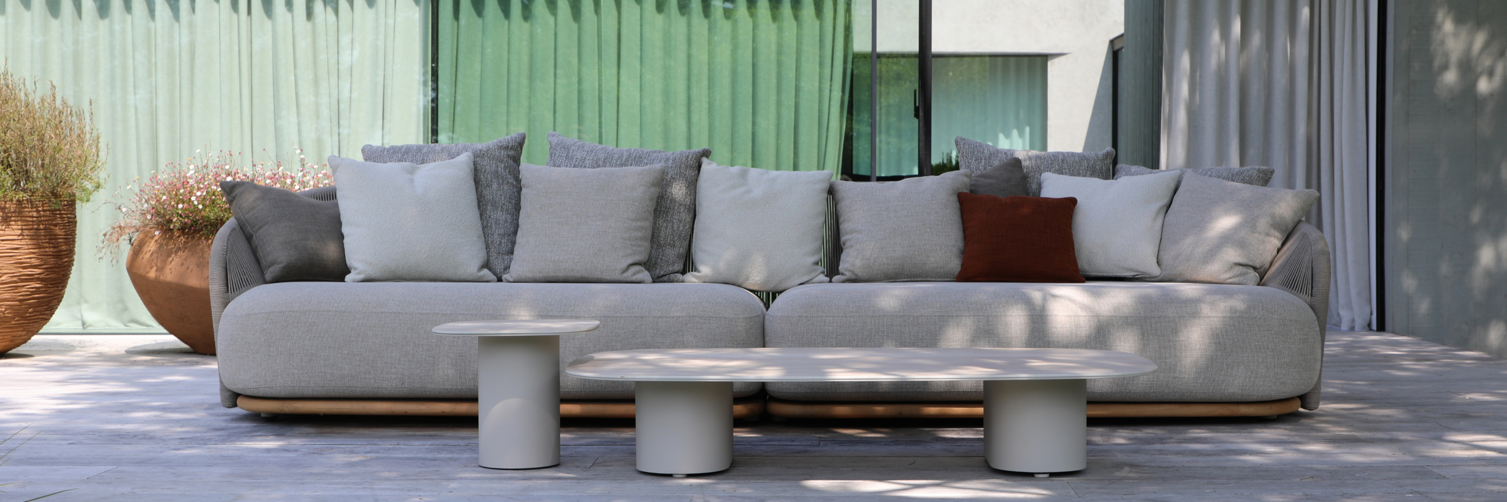 Pebl outdoor sofa with neutral cushions and modern coffee tables – luxury patio furniture in South Africa