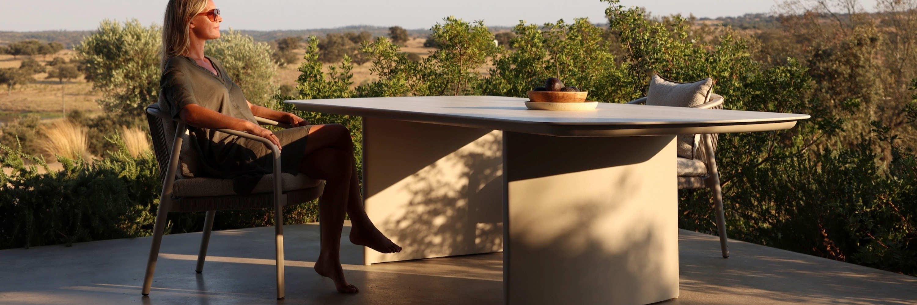 Luxury outdoor dining furniture set with modern dining table and chairs beside a pool in a South African outdoor living space