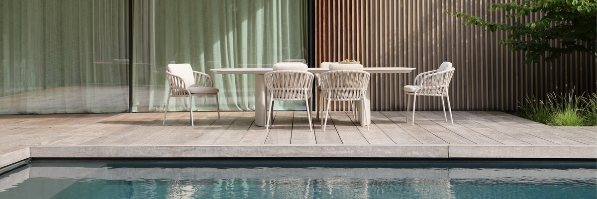 Luxury outdoor dining furniture set with modern dining table and chairs beside a pool in a South African outdoor living space