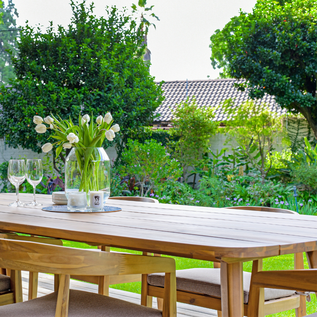 Wood outdoor dining table in garden setting