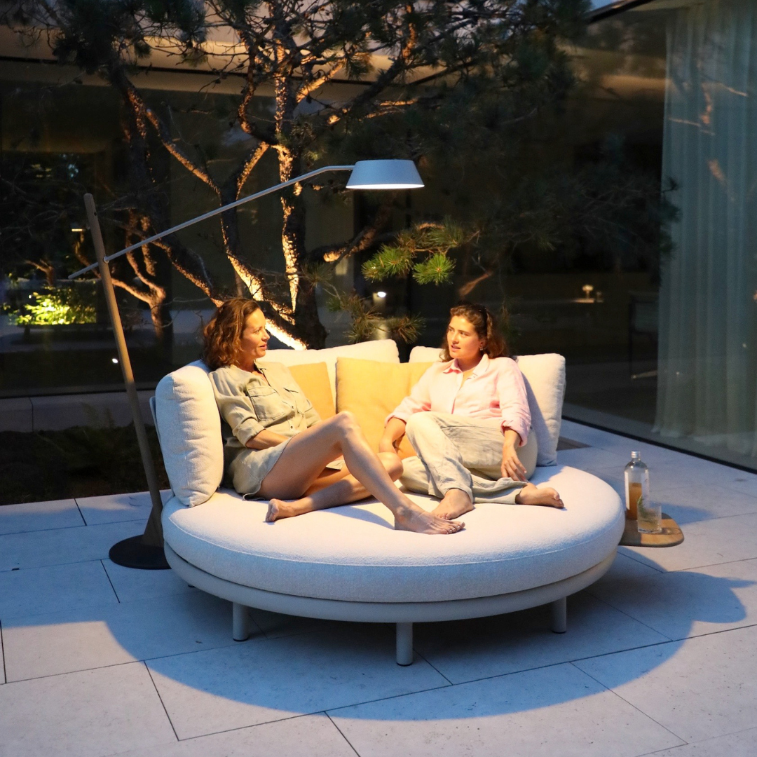 Cloud Island Outdoor Daybed at night with two people seated outdoors