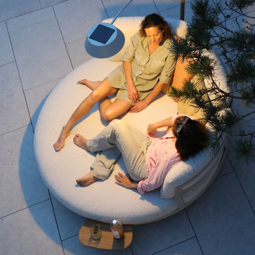 Top view of people relaxing on the Cloud Island Outdoor Daybed at night