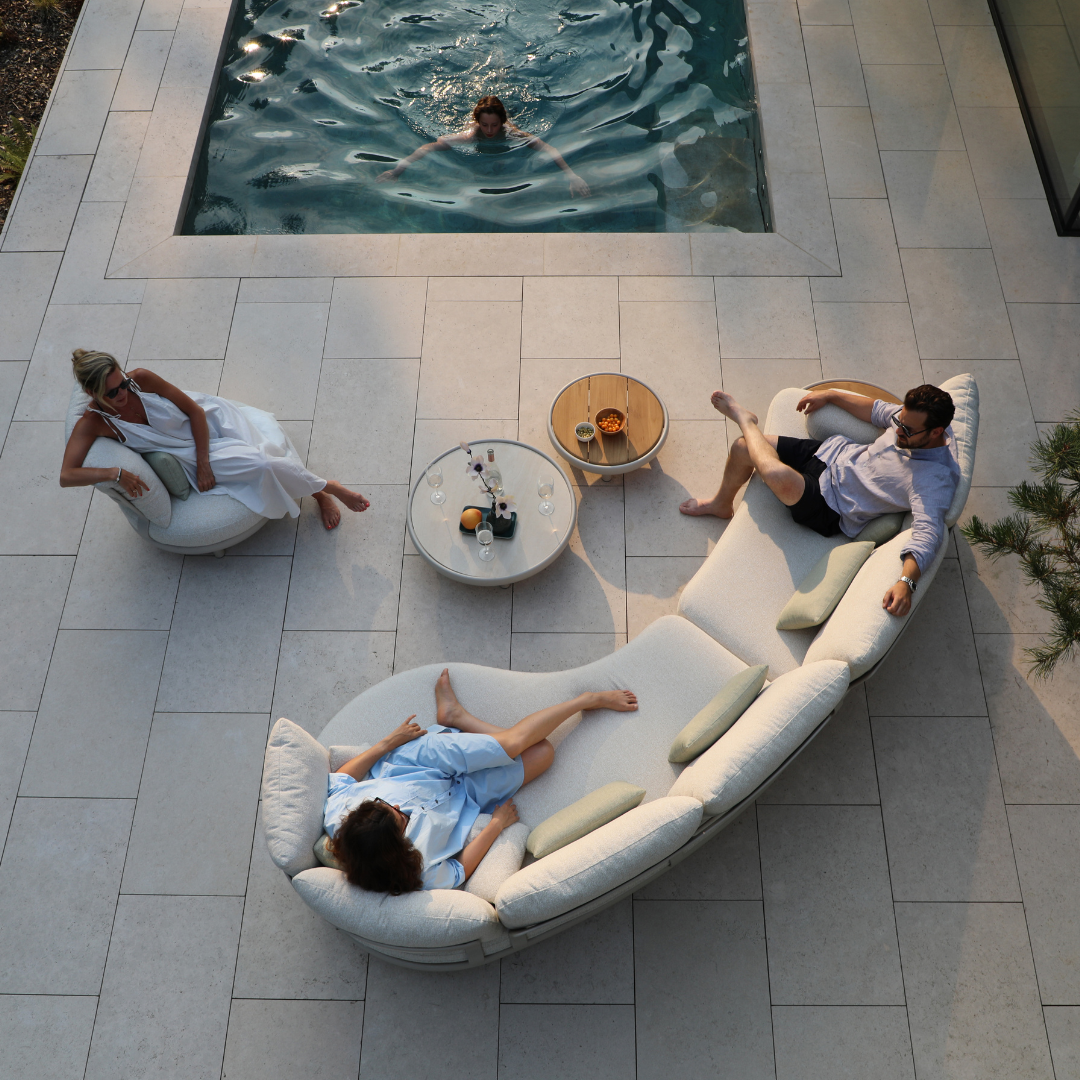 Top view of people sitting on curved outdoor sofa lounge set