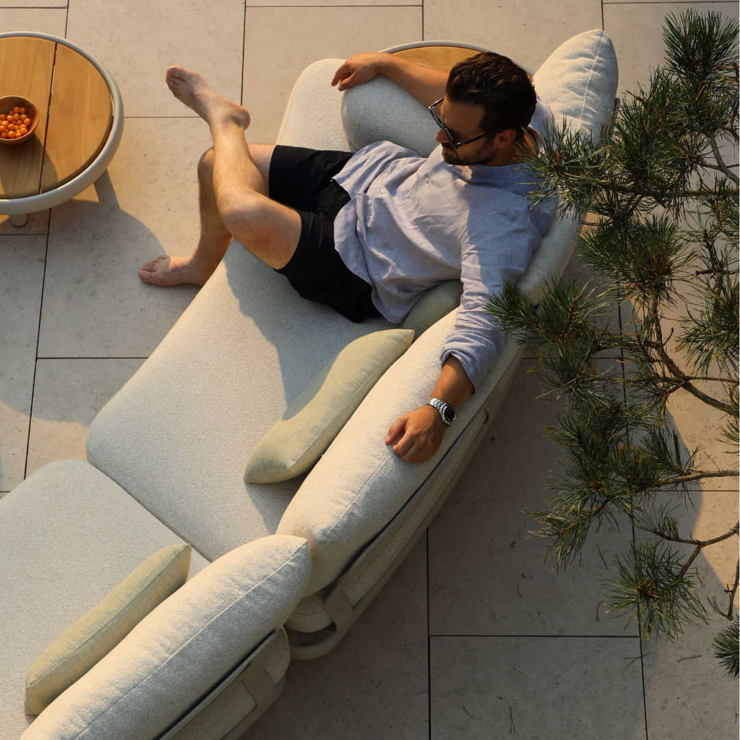 People relaxing on Cloud curved outdoor sofa garden patio setting