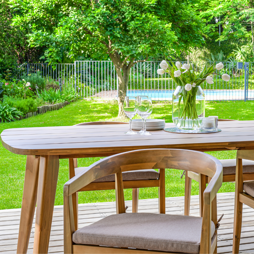 Rounded wood outdoor dining table with matching chairs