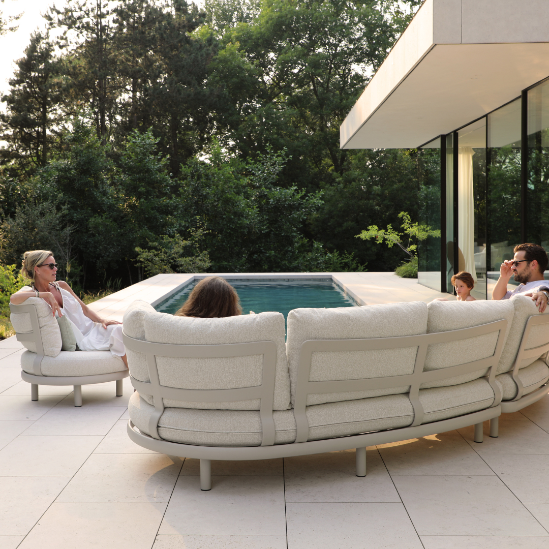 Cloud curved outdoor sofa lifestyle setting in garden patio
