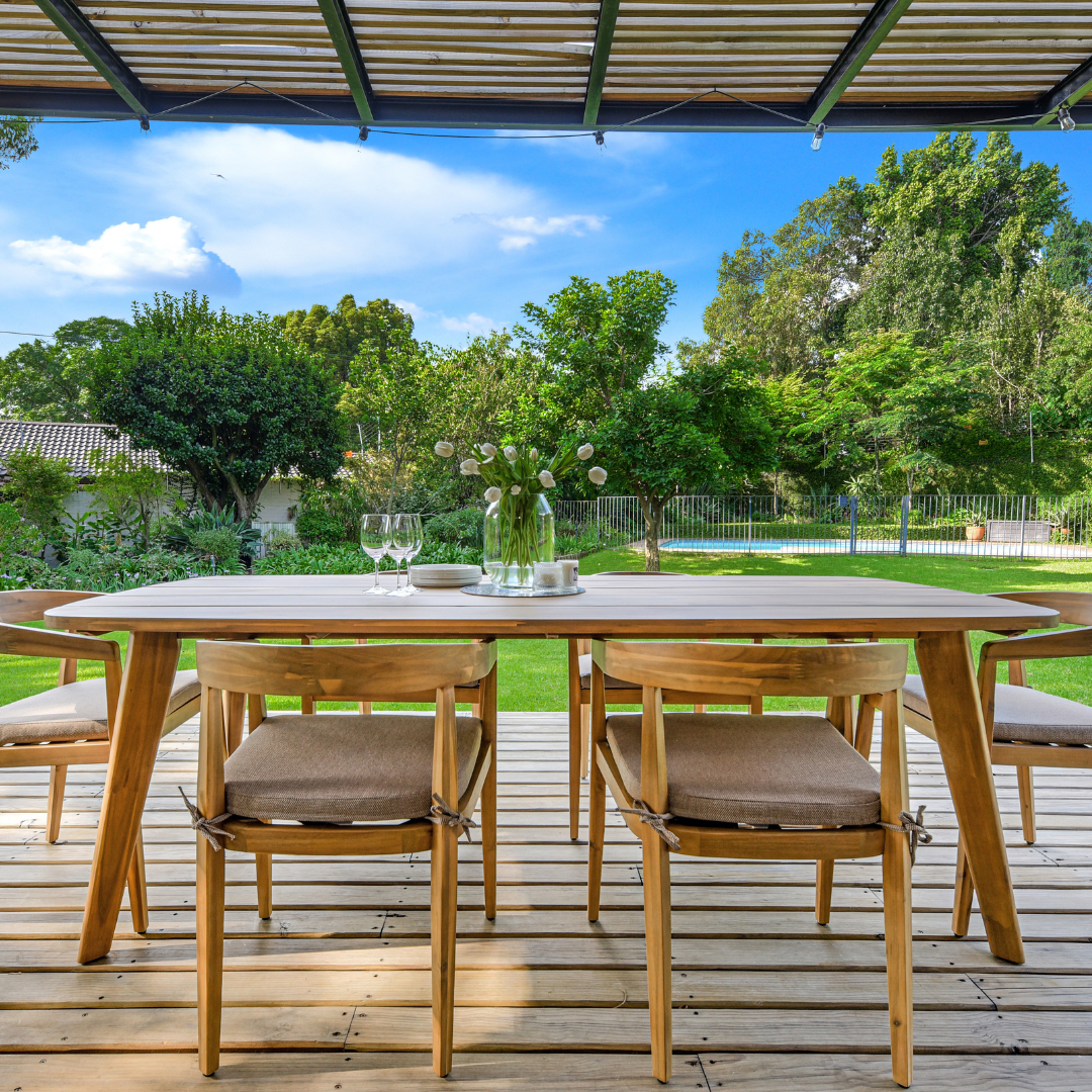 Modern wooden outdoor dining table and chairs on deck