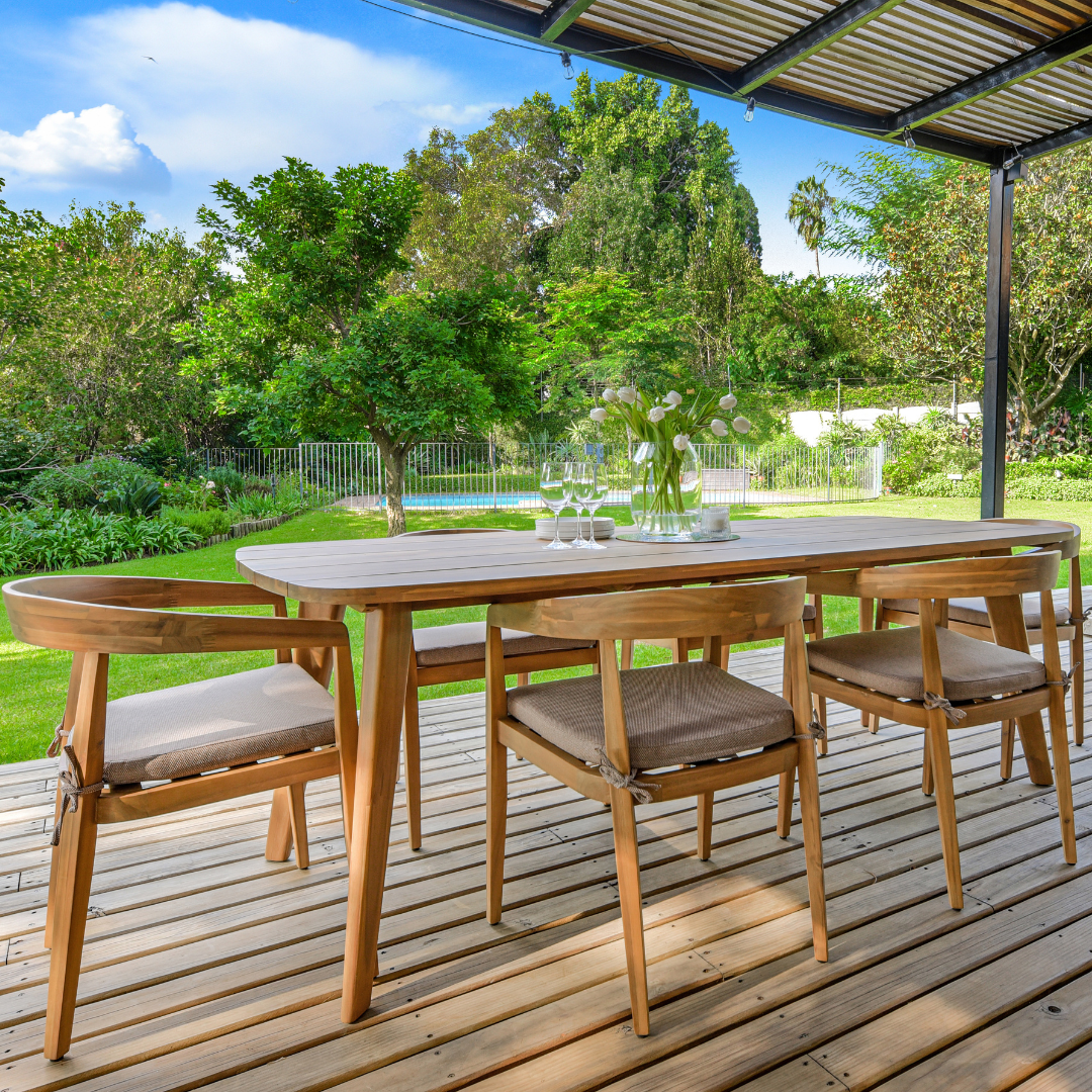 Spacious wood outdoor dining table set under pergola