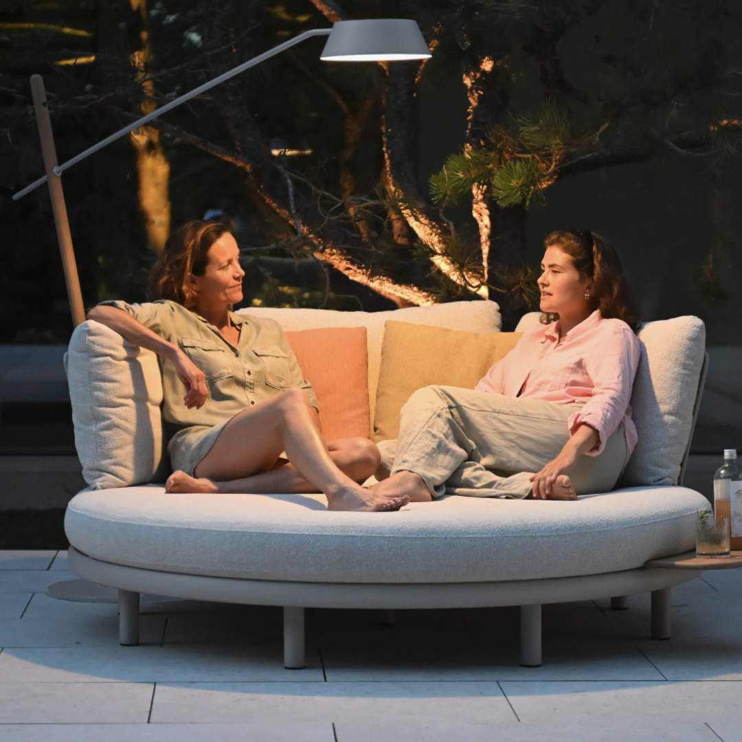 Outdoor lights illuminating a garden table with warm, modern solar lighting